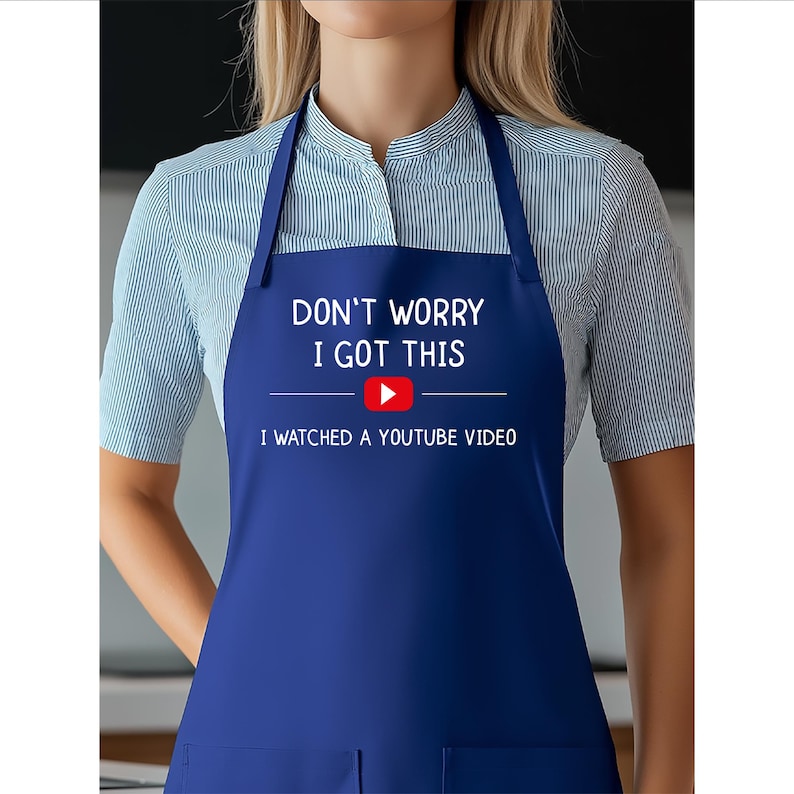 May include: A navy blue apron with the text "DON'T WORRY I GOT THIS" above a YouTube play button logo and the text "I WATCHED A YOUTUBE VIDEO". The apron has a bib and neck strap.