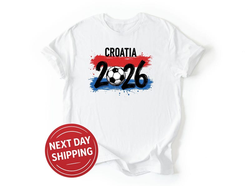 May include: White t-shirt with the word "CROATIA" above the number "2026" and a soccer ball graphic. The design incorporates red, white, and blue colors, resembling a flag. A red circle with the text "NEXT DAY SHIPPING" is at the bottom.