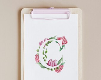 May include: A white clipboard with a pink clip holds a white sheet of paper with a watercolour illustration of the letter C surrounded by pink roses and green leaves.