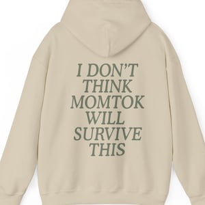 May include: A beige hoodie with a green text print on the back that reads "I don't think momtok will survive this".