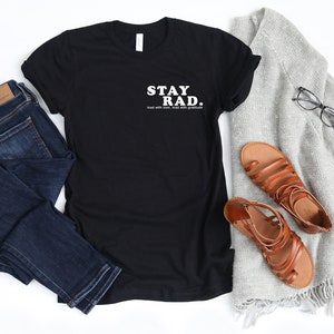 May include: Black t-shirt with white text that reads "STAY RAD.  Read with love, read with gratitude."