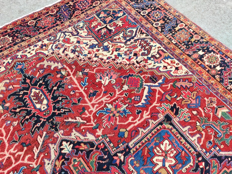 May include: A red, blue, and white Persian rug with a floral pattern. The rug has a central medallion and a border with intricate designs.