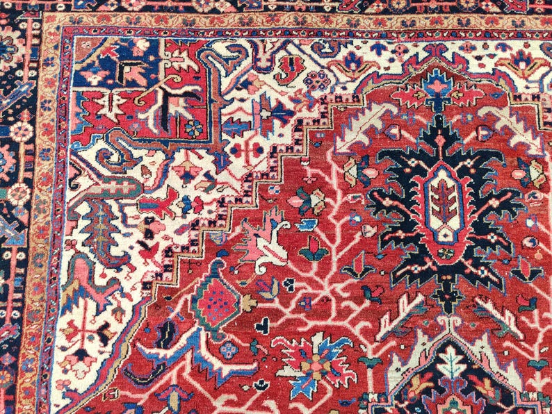May include: A red, blue, and white Persian rug with intricate floral and geometric patterns. The rug has a central medallion and a border with a repeating design.