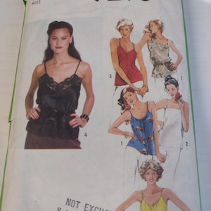 May include: Simplicity 9296 sewing pattern featuring various women's tops. The pattern includes a black lace-trimmed camisole, a red tank top, a blue patterned top, a white top, and a yellow top. The size is 10 Miss.