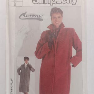 May include: Simplicity pattern 1748 for a long coat with a collar and button closure. The pattern is for sizes 18, Eur 45. The pattern is from the Connoisseur Collection.