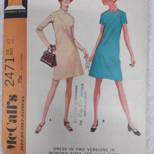 May include: A vintage sewing pattern for a dress in two versions. The pattern is McCall's 2471 and is for women's sizes and half sizes. The pattern is 75 cents and is available in Canada for 85 cents.