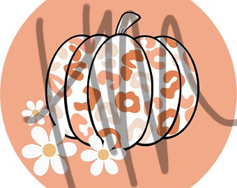 May include: A digital illustration of a pumpkin with a leopard print pattern in shades of orange and white, set against a peach-colored circle. White daisies with yellow centers are at the bottom left, with a shadow of the word "KIND" over the pumpkin.