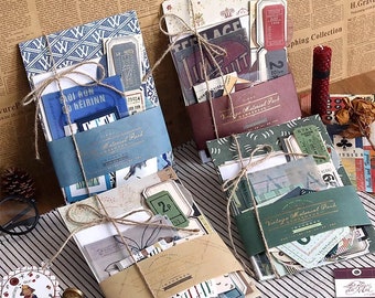 May include: Four packages of vintage craft supplies, each wrapped in brown paper and twine. The packages contain various paper ephemera, including tickets, tags, and patterned paper. The packages are labeled "Vintage Material Pack".