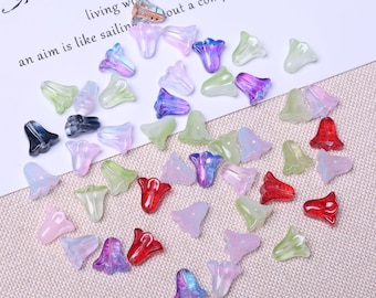 May include: A collection of translucent flower-shaped beads in various colors, including red, green, purple, and white. The beads are scattered on a light-colored surface, with text that reads "LIFE" and "an aim is like sailing..."