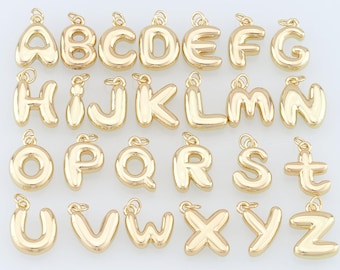 May include: A set of 26 gold-colored metal alphabet letter charms. Each letter is in a balloon-like shape.