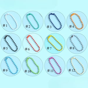 May include: A collection of twelve ball chain keychains in various colors, including white, teal, navy, orange, black, red, yellow, gray, light blue, green, pink, and cream. Each keychain is labeled with a number from #1 to #12.