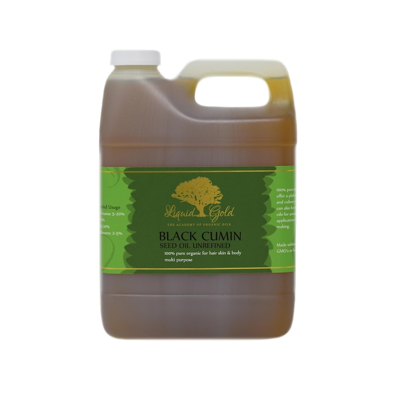May include: A gallon jug of Liquid Gold Black Cumin Seed Oil Unrefined. The label is green with a gold tree and the text "Liquid Gold The Alchemy of Organic Oils Black Cumin Seed Oil Unrefined 100% pure organic for hair skin & body multi purpose".
