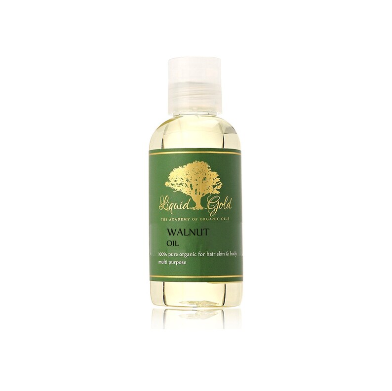 Pode incluir: Uma garrafa de vidro transparente com um r&oacute;tulo dourado que diz "Liquid Gold The Academy of Organic Oils Walnut Oil 100% pure organic for hair skin & body multi purpose".