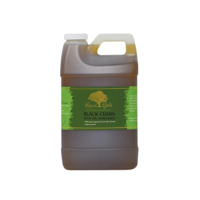 May include: A gallon jug of Liquid Gold Black Cumin Seed Oil, unrefined. The label is green with a gold tree and text. The oil is a dark amber color.