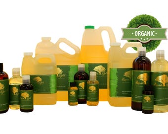 May include: A variety of sizes of organic olive oil bottles, ranging from small 4 oz bottles to large 1 gallon jugs. The bottles are all labeled with the words "Liquid Gold" and a green tree logo. The bottles are arranged on a white background with a green wreath and the word "ORGANIC" in a banner.