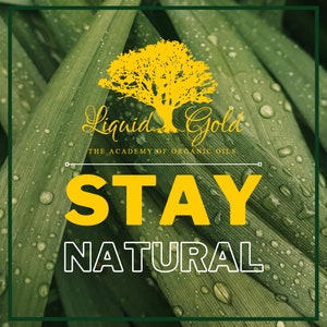 May include: A green leafy background with water droplets. The text "STAY NATURAL" is in yellow letters with a white outline. The text "Liquid Gold" is in cursive script with a yellow tree image. The text "THE ACADEMY OF ORGANIC OILS" is below the cursive text.