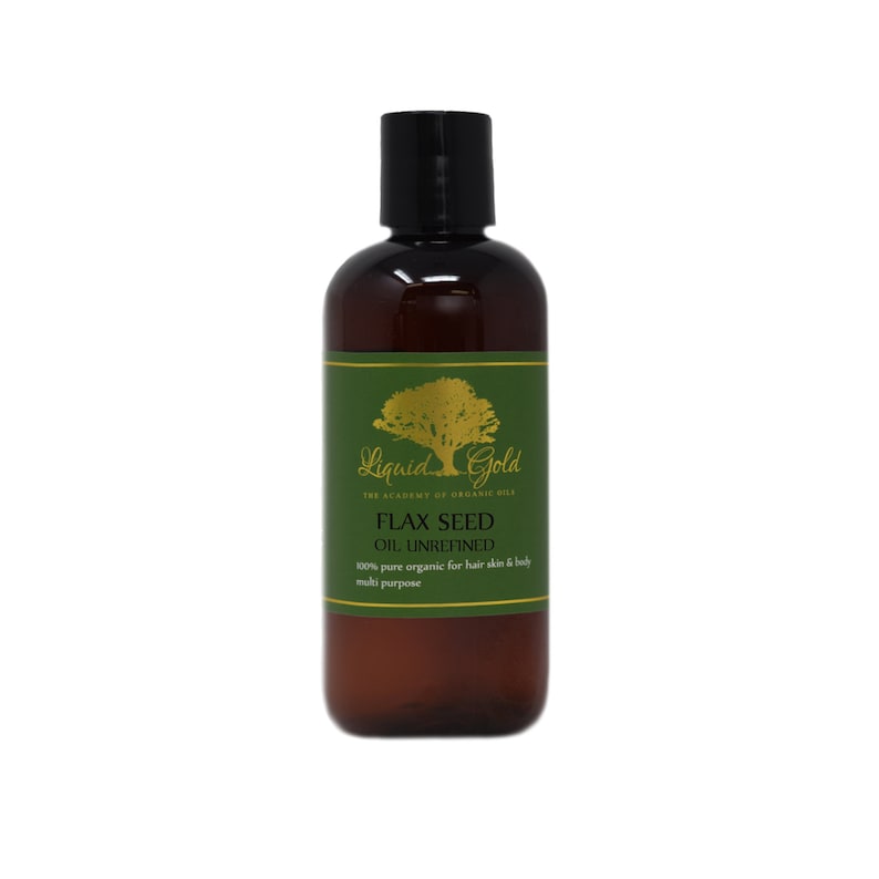 May include: A brown bottle with a green label that says "Liquid Gold The Academy of Organic Oils Flax Seed Oil Unrefined 100% pure organic for hair skin & body multi purpose"
