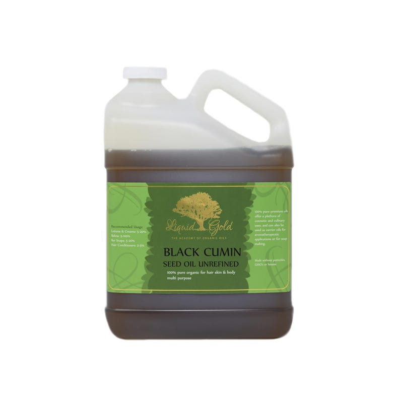 May include: A gallon jug of Liquid Gold Black Cumin Seed Oil Unrefined. The label is green and gold with a tree logo and the text "Liquid Gold The Alchemy of Organic Oils".
