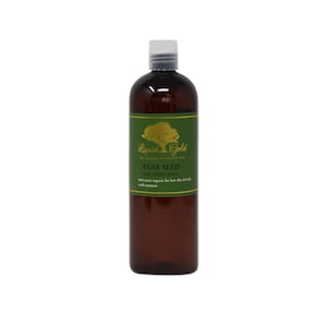 May include: A brown glass bottle of Liquid Gold Flax Seed Oil Unrefined. The bottle has a green label with a gold tree and the words "Liquid Gold" and "The Academy of Organic Oil". The label also says "Flax Seed Oil Unrefined", "100% pure organic for hair skin & body", and "multi purpose".