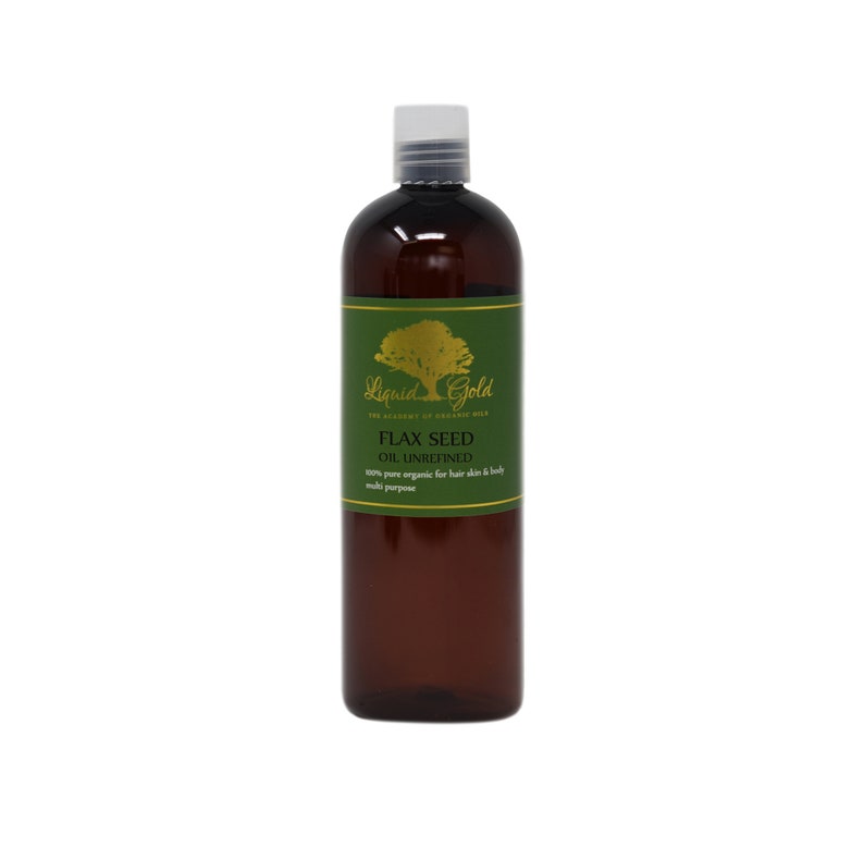 May include: A brown glass bottle of Liquid Gold Flax Seed Oil Unrefined. The bottle has a green label with a gold tree and the words "Liquid Gold" and "The Academy of Organic Oil". The label also says "Flax Seed Oil Unrefined", "100% pure organic for hair skin & body", and "multi purpose".