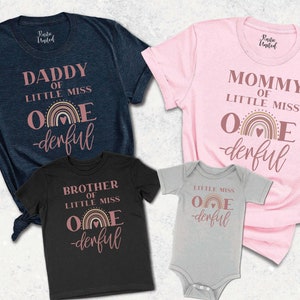 May include: Four t-shirts and a onesie with matching designs. The shirts are navy blue, black, and pink, and the onesie is gray. Each item has the text "Daddy of Little Miss One-derful", "Mommy of Little Miss One-derful", "Brother of Little Miss One-derful", and "Little Miss One-derful".