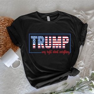 May include: Black t-shirt with a blue and red American flag design that says "TRUMP was right about everything" in white text.