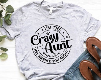 May include: Gray t-shirt with a black circle graphic that says "I'm the Crazy Aunt They Warned You About".