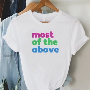 May include: White t-shirt with the text "most of the above" in pink, green, and blue lettering.
