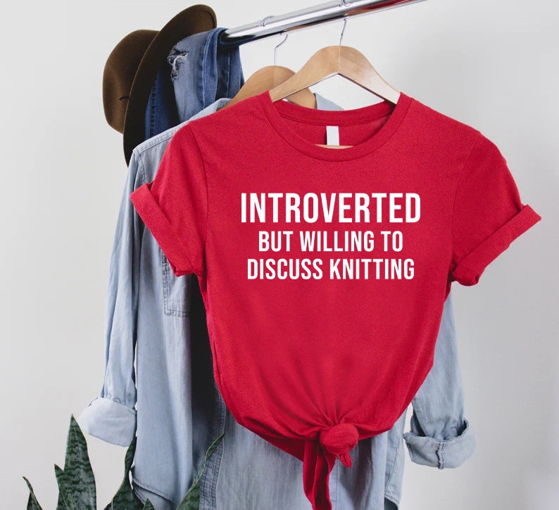 a t - shirt that says, interrupted but willing to discuss knitting