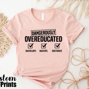 a pink t - shirt with the words dangerously overducated on it