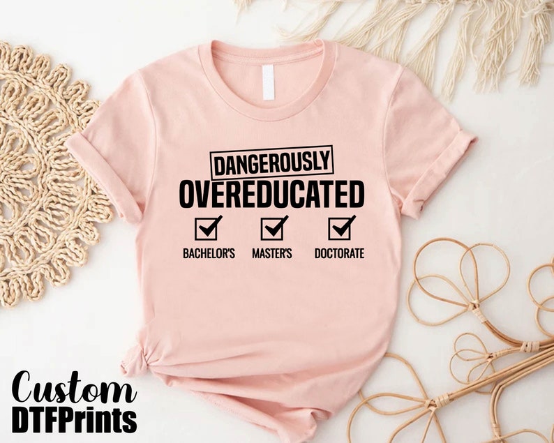 a pink t - shirt with the words dangerously overducated on it