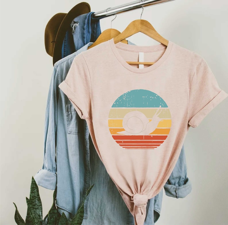 a t - shirt with a picture of a snail on it