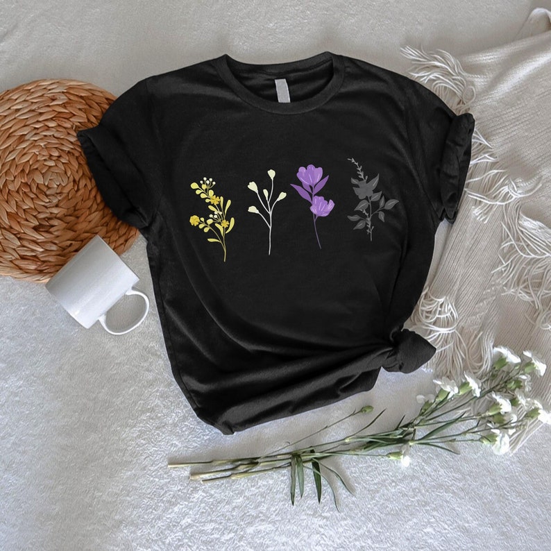 a black t - shirt with three flowers on it