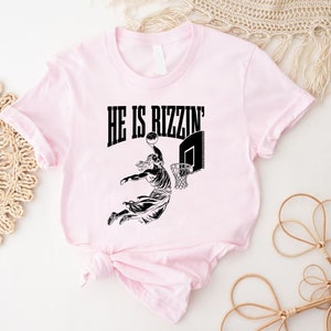 a t - shirt with a picture of a person jumping out of a door