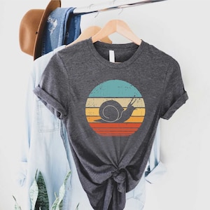 a t - shirt that has a snail on it