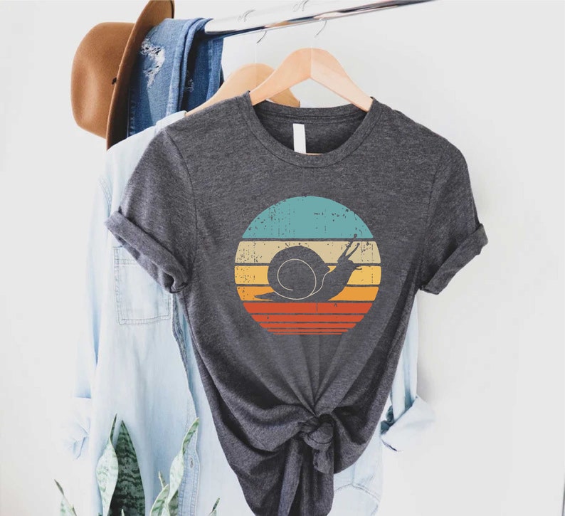 a t - shirt that has a snail on it