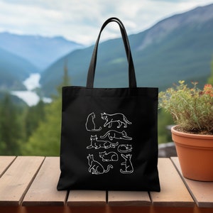 a black tote bag sitting on top of a wooden table