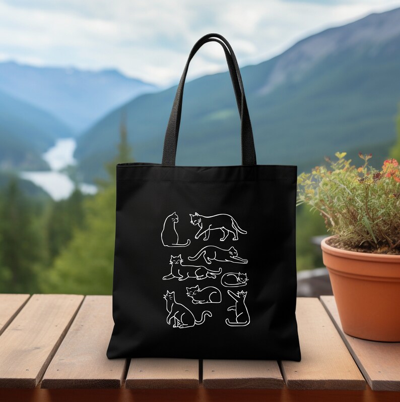 a black tote bag sitting on top of a wooden table