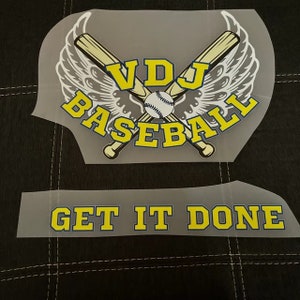 May include: Two iron-on transfers for a baseball jersey. The top transfer features a baseball bat and ball with wings and the text "VDJ Baseball". The bottom transfer says "Get It Done".