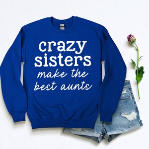 a blue sweatshirt that says crazy sisters make the best pants