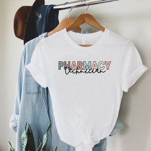 May include: White t-shirt with the text "PHARMACY Technician" in rainbow colors.