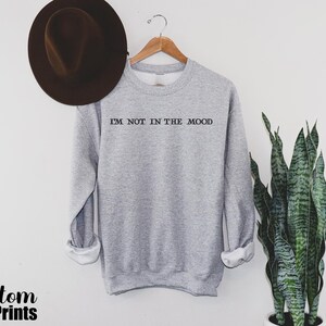 a hat and a sweatshirt hanging on a wall