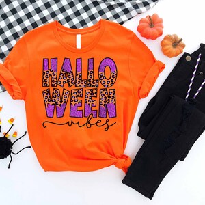 an orange shirt with the words halloween written on it
