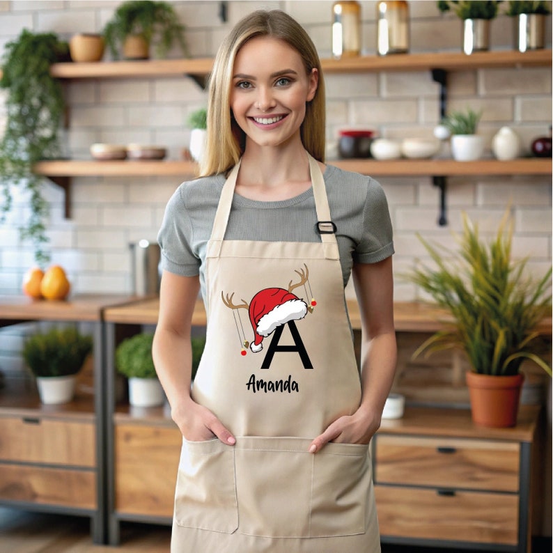 a woman wearing an apron with a santa hat on it