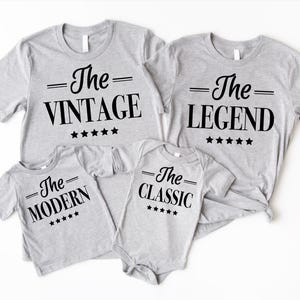 May include: Four grey t-shirts with black text and stars. The shirts say "The Vintage", "The Legend", "The Modern", and "The Classic".