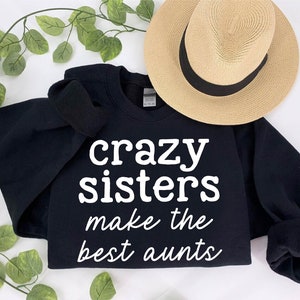 a black shirt that says crazy sisters make the best aunts