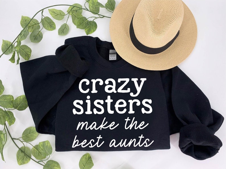 a black shirt that says crazy sisters make the best aunts