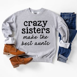 a gray sweatshirt that says crazy sisters make the best pants
