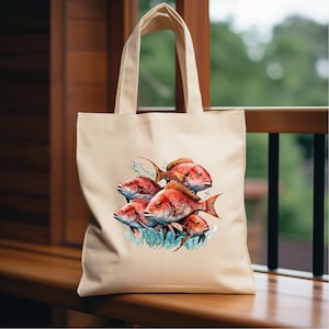 May include: A beige canvas tote bag with a colorful illustration of red snapper fish. The fish are depicted in a realistic style with splashes of water and bubbles.