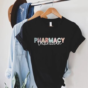 May include: Black t-shirt with the text "PHARMACY Technician" in colorful letters.